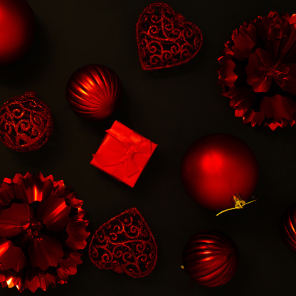 Creative Christmas composition on a black  background with red Xmas ornaments. New Year aesthetic concept. Flat lay.