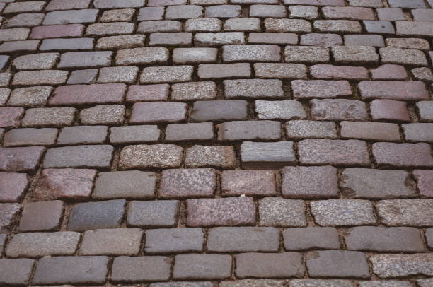 istock Old pavement lined with stone, stone pavement background close-up. 1436967730