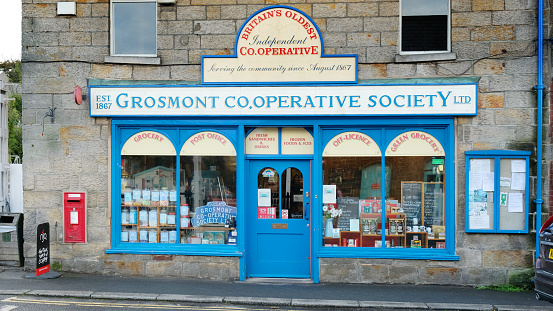Grosmont, North Yorkshire, UK - 26th September, 2022: Exterior view of the Grosmont Co-Op store, the oldest in Britain. Situated on the North York Moors, it is a popular tourist destination for visitors from all over the country.