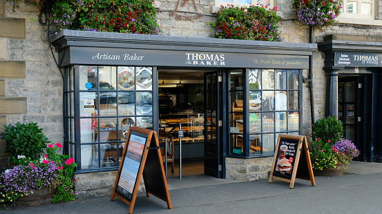 Helmsley, North Yorkshire, UK - 27th September, 2022: Exterior view of an artisan baker shop situated in the town square at Helmsley, Yorkshire. Helsmsley is a picturesque town on the edge of the North York Moors, a popular location for tourists from all over the country.