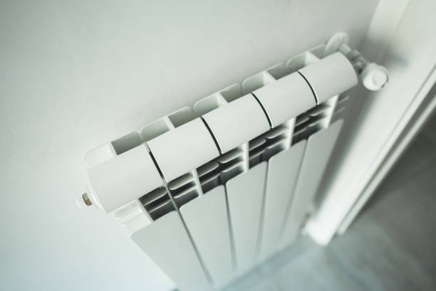 istock Metal radiator with adjustable valve inside the apartment. 1436968320