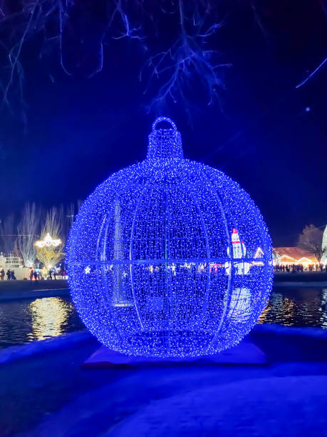 Giant Christmas ball illuminated blue at night