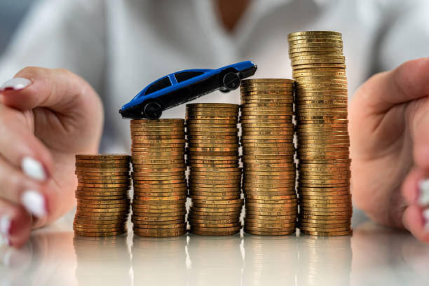 istock woman on a mirrored table on a roller coaster with coins drives the car up. 1436970158