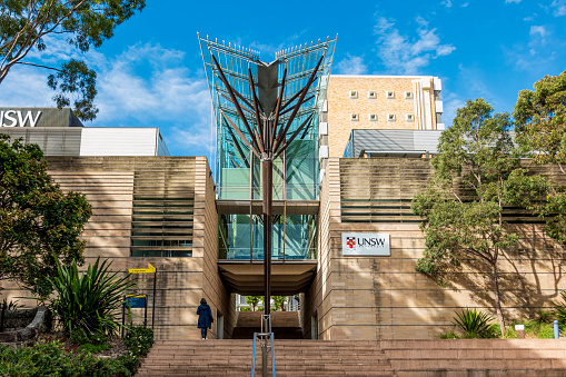 Sydney, Australia - May 20, 2021: Steps to Tree of Knowledge architectural structure of The John Niland Scientia Building at the University of New South Wales. UNSW plaque on the wall.