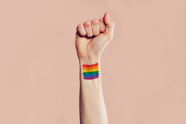 istock Hand with rainbow flag painted on the arm 1436972405