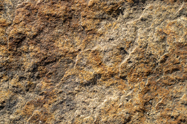 istock Raw red granite rock texture background. Fragment of natural stone wall 1436973320