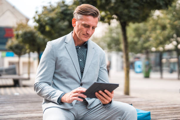 istock Mature Caucasian Businessman Working With A Digital Tablet 1436974124