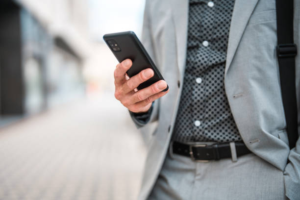 istock Successful Caucasian Businessman Wearing A Suit And Using A Smart Phone 1436974135
