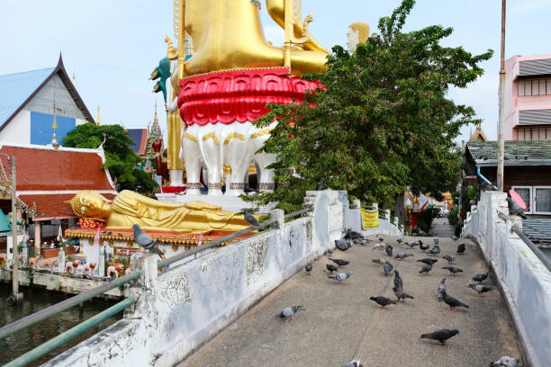 Pigeons on a small bridge over Khlong Dan canal at the Wat Khunchan, in Thonburi district, Thailand.