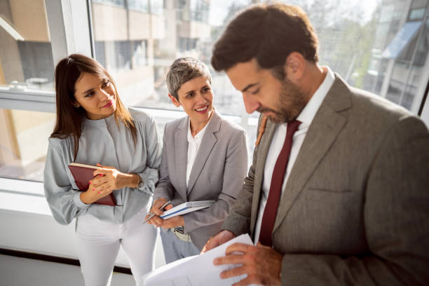istock Team of corporate professionals in office corridor 1436979262