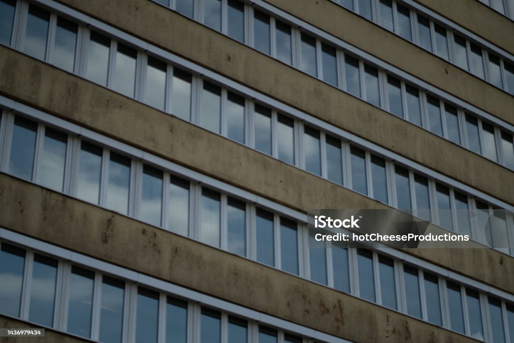 Lots of hospital windows next to each other Lots of office windows next to each other on an old brick building Architecture Stock Photo