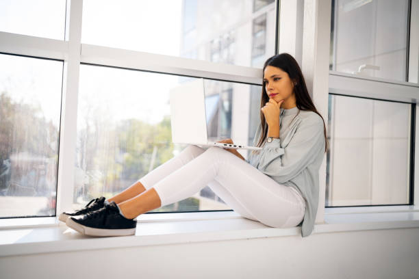 istock College student using laptop in the hall of university building 1436980518