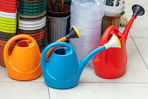 Plastic colorful watering cans gardening tools sold on market
