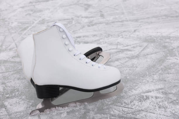 istock Pair of figure skates on ice, space for text 1436981609