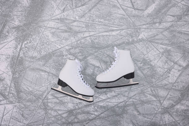 Pair of figure skates on ice, flat lay