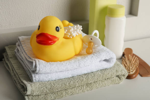 istock Bathroom towels, toy and baby accessories on white table 1436983394