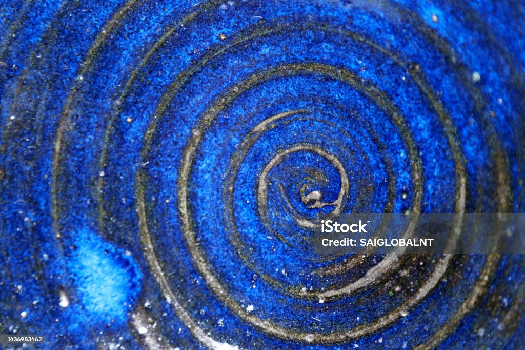 Platter with a swirling design, vividly baked with a cobalt blue glaze. Pottery texture. Tanzanite Stock Photo