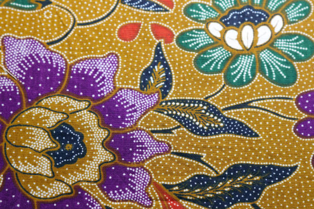 istock Ocher color based Batik fabric with oriental purple and white floral texture. 1436983492