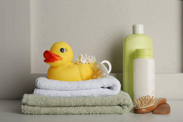 istock Bathroom towels, toy and baby accessories on white table 1436983803