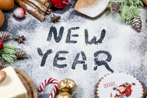 istock Happy New year. Frame of kitchen tools, Christmas decorations gingerbread, cinnamon, Christmas tree on a dark background. Greeting card for the New year. Concept of cafes and restaurants. 1436984659