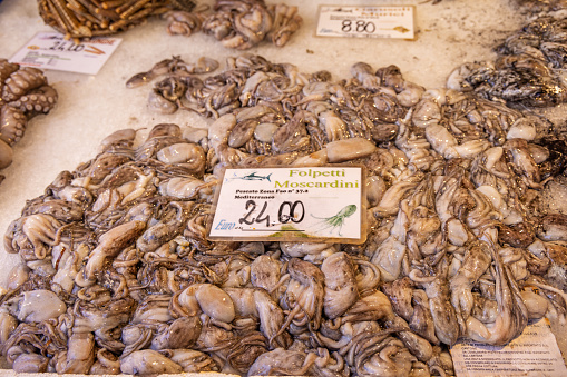 Venice, Italy - October 7th 2022: Squid at a fishmongers desk at the open air fish marked in the center of the old Italian city Venice
