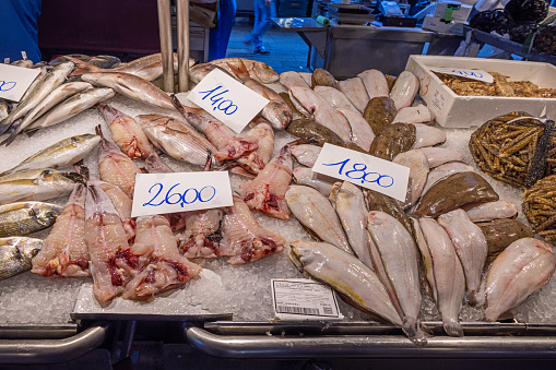 Venice, Italy - October 12th 2022: Fresh fish on ice at a fish vendors table at the outdoor fish market in the center of the old Italian city Venice