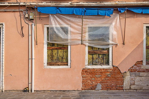 Venice, Italy - October 6th 2022: An abandoned residential building in the center of the old Italian city Venice