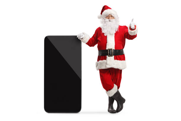 istock Santa claus leaning on a big smartphone and gesturing thumbs up 1436986708