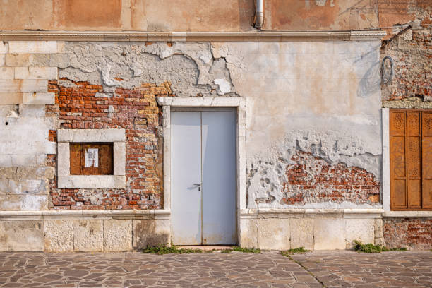 Venice, Italy - October 6th 2022: Abandoned house in late afternoon sunlight in the center of the old Italian city Venice
