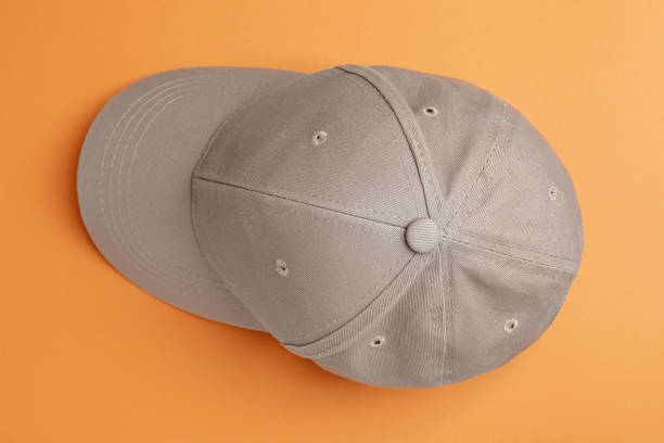 istock Stylish grey baseball cap on orange background, top view 1436987724