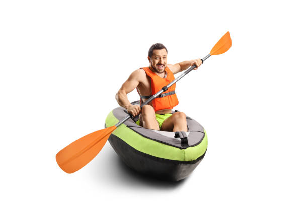 istock Smiling young man riding a canoe with a life vest 1436989757