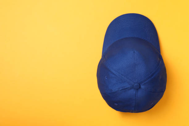 istock Stylish blue baseball cap on yellow background, top view. Space for text 1436991256