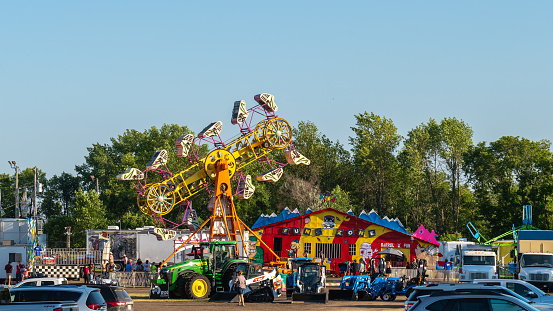 West Springfield, Massachusetts, USA-September 18, 2014- Smiling fairgoers stroll past the colorful food vendors at the annual Eastern States Exposition.