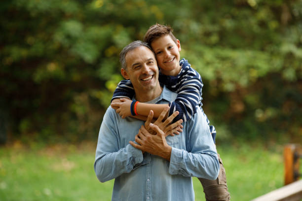 istock Happy single father and son having fun while talking in nature. 1436991956