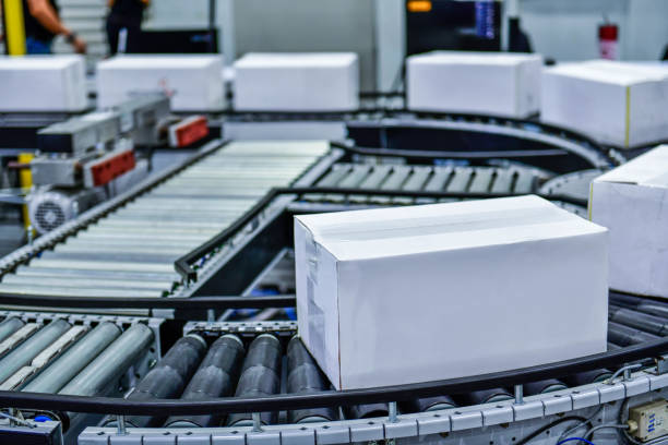 istock White paper box on conveyor belt. parcels transportation system concept 1436992489