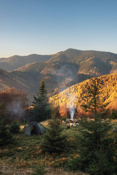 istock Tourist tent in the mountains under dramatic evening sky. Colorfull sunset in mountains. Camping travell concept. Traveler people enjoying the advanture alternative vacation 1436993321