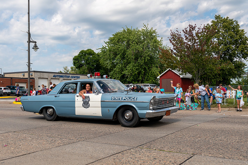 Mora, Minnesota USA July 30, 2022  Parade in Mora, Minnesota for the Kanabec County Fair. Vintage baby blue police car.