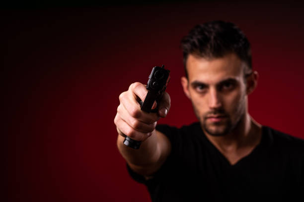 istock A man holding a gun in hand, the ship ready to shoot the man pointed 1436993748