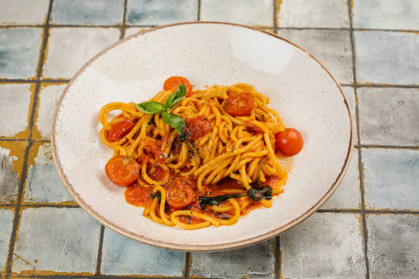istock Spaghetti Pasta with tomato, Pasta with tomato sauce, Grey stone background. Top view. Close up. 1436993844