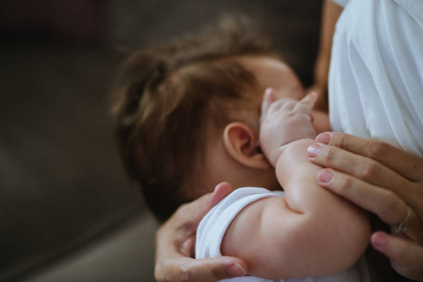 istock Adorable little newborn being breastfed 1436995820