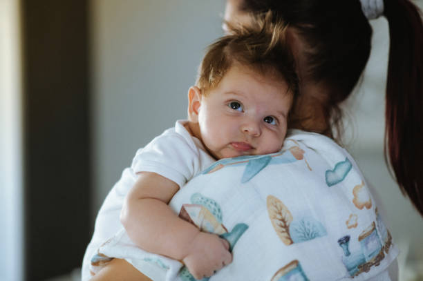 istock Cute little baby boy being held by his mom 1436995864