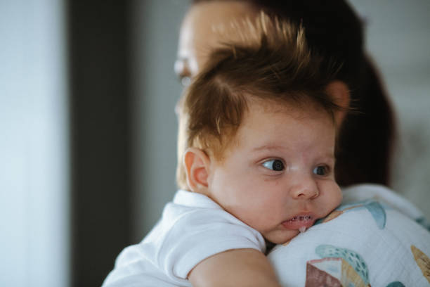 istock Baby boy drooling on his mothers shoulder 1436995909