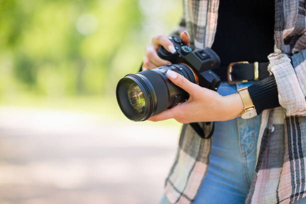 istock Freelance female photographer holding a camera. Creative occupation concept 1436996296