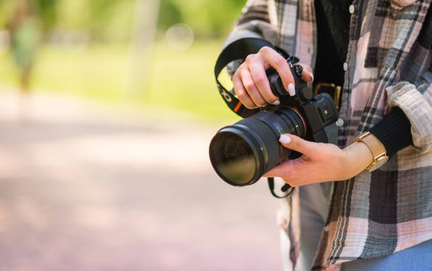 istock Freelance female photographer holding a camera. Creative occupation concept 1436996838