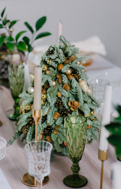 istock A decorated mini Christmas tree among Stylish table setting close-up on Christmas Eve. 1437000244