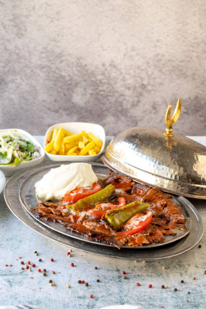 Turkish iskender kebab on gray background. Traditional flavors. Doner kebab made from beef and lamb. close up stock photo