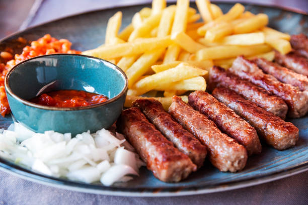 Traditional Cevapcici, ground meat rolls with french fries. Porec, Croatia. stock photo