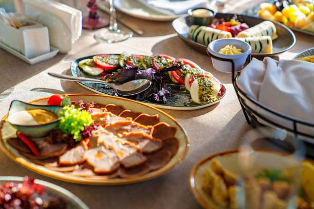 salads and cold cuts. a table served with utensils and snacks for lunch. catering services for family feasts.