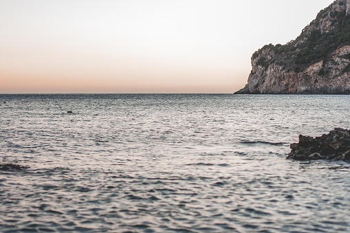 Corfu, Greece. Beautiful landscape with a huge rock in the water at sunset