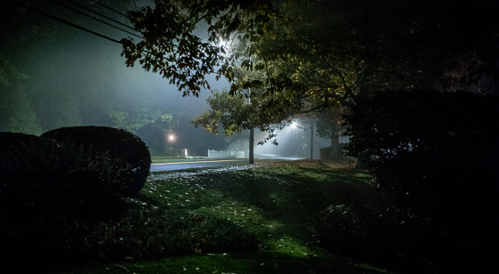 Views of a residential street in Wellesley Hills, MA at around 10PM on a foggy, misty evening.  Wellesley Hills is a suburb of Boston, MA in New England USA.